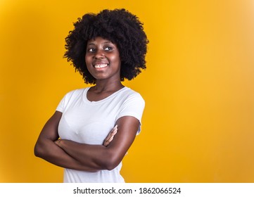 Black Woman With Arms Crossed On Yellow Background