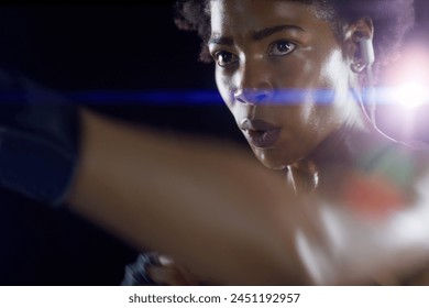 Black woman, athlete and boxing punch with arm on dark background for night training, earphones or sweat. Female person, fitness and professional martial arts or self defense class, fight or sport - Powered by Shutterstock