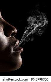 Black Woman Blowing Tobacco Smoke