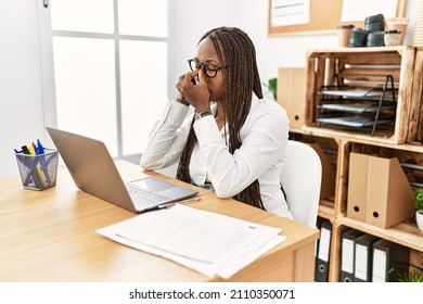 Black Woman With Braids Working At The Office Speaking On The Phone Tired Rubbing Nose And Eyes Feeling Fatigue And Headache. Stress And Frustration Concept. 