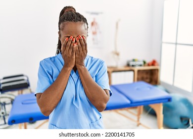 Black Woman With Braids Working At Pain Recovery Clinic Rubbing Eyes For Fatigue And Headache, Sleepy And Tired Expression. Vision Problem 