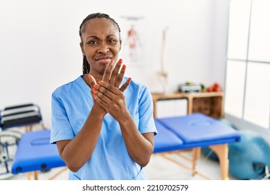 Black Woman With Braids Working At Pain Recovery Clinic Suffering Pain On Hands And Fingers, Arthritis Inflammation 