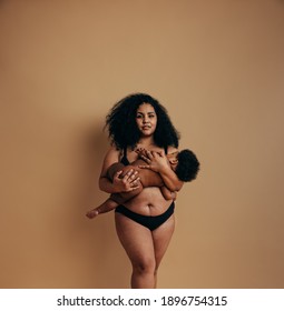 Black woman breastfeeding her infant. Woman experiencing beautiful motherhood.