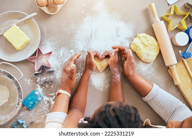 Black woman, child hands or kitchen baking of heart shape pastry, house cookies or dessert biscuit scone in family home. Top view, mother or girl cooking food in help, support or learning cake recipe - Powered by Shutterstock