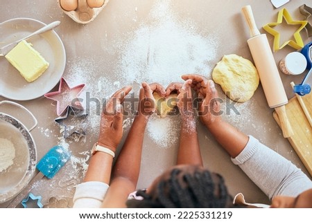 Black woman, child hands or kitchen baking of heart shape pastry, house cookies or dessert biscuit scone in family home. Top view, mother or girl cooking food in help, support or learning cake recipe