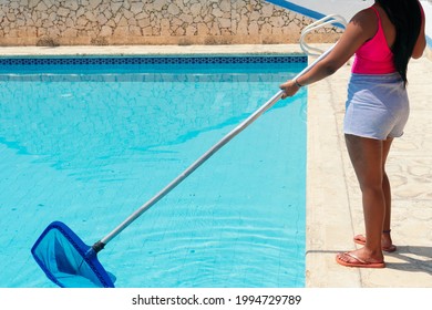 Black Woman Is Cleaning The Swiming Pool