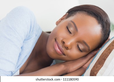 Black Woman With Closed Eyes In A Living Room