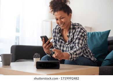 Black Woman Connecting Phone To Her Virtual Assistant Smart Speaker