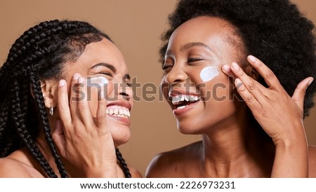 Black woman, cream and skincare with friends support, love and beauty together in studio for cosmetics, makeup cleaning and facial. Excited, diversity model with sunscreen or essential oil on face