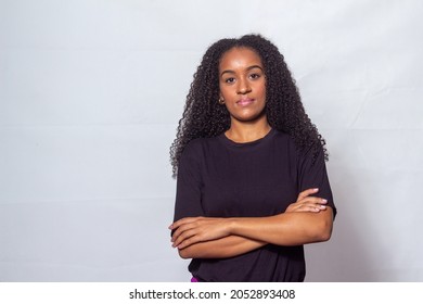 Black Woman With Curly Hair On Neutral Color Background.