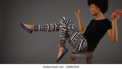 Black woman dancing on chair