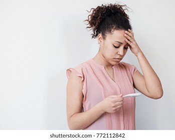 Black woman desperate after reading pregnancy test result and empty copy space for text