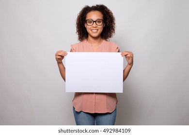 Black woman displaying white banner isolated on background - Powered by Shutterstock