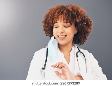 Black woman, doctor and Covid, remove face mask and health, end of pandemic and protection on studio background. Face, smile and mockup with healthcare, safety from virus and positivity with female - Powered by Shutterstock