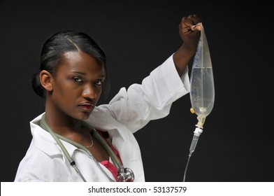 A Black Woman Doctor Holding An IV Bag