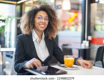 Black Woman Drinking An Orange Juice