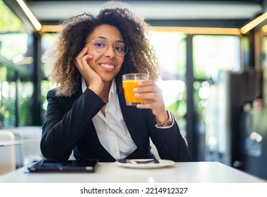 Black Woman Drinking An Orange Juice