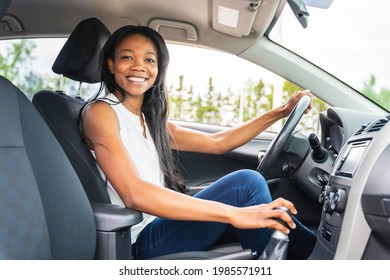 A Black Woman Driver Seated In Her New Car