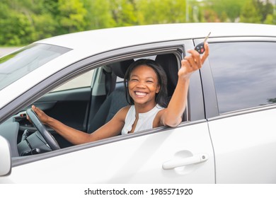A Black Woman Driver Seated In Her New Car