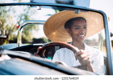 Black Woman Driving A Vintage Convertible Car