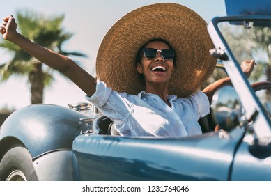 Black Woman Driving A Vintage Convertible Car