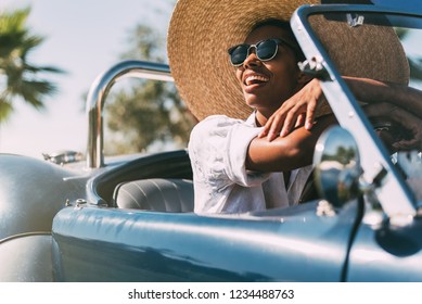 Black Woman Driving A Vintage Convertible Car