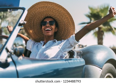 Black Woman Driving A Vintage Convertible Car