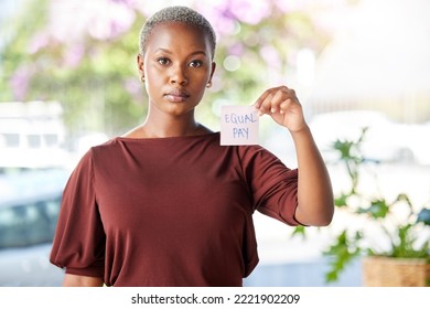 Black Woman, Equal Pay And Paper Sign For Financial Equality, Compensation And Fair Salary On City Background. Portrait, Note And Pay Gap By Worker Serious About Equity, Change And Fair Opportunity