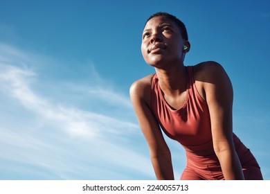 Black woman, exercise or tired after training, running or workout for balance, wellness or health outdoor. Sky, African American female, runner or athlete relax, breathing or focus for cardio or rest - Powered by Shutterstock