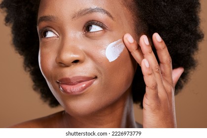 Black woman, face cream and beauty, sunscreen makeup product and luxury facial treatment on studio background. Young african model, body lotion and cosmetics for healthy skincare, wellness and shine - Powered by Shutterstock