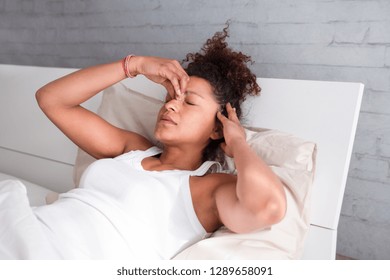 Black Woman Feeling Sick And Uncomfortable In Bed