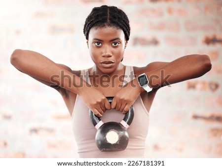 Black woman, fitness and kettlebell with focus and exercise in gym, weights and muscle training with strong athlete and bodybuilding. Bodybuilder, workout and sport motivation with wellness portrait.