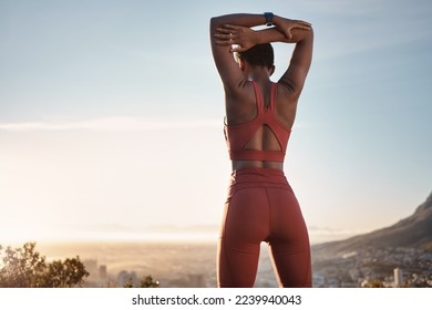 Black woman, fitness and stretching arm on mountain for exercise, workout or training during sunset in outdoors. African American woman in warm up stretch on cliff in sunrise or active life in nature - Powered by Shutterstock