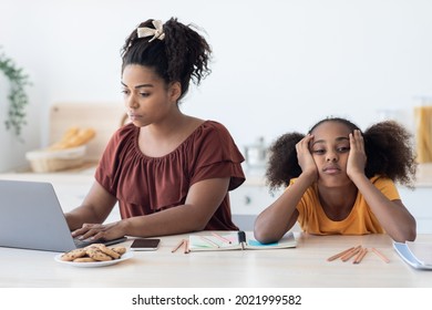 Black Woman Freelancer Typing On Laptop, Working From Home, Bored Daughter Sitting By Her, Leaning On Her Hands, Single Mother Does Not Paying Attention To Her Kid Teen Girl, Kitchen Interior