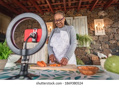 Black Woman With Glasses Teaches Online With Her Mobile Phone Cooking Classes From Home