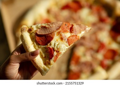 Black Woman Hand Holding Slice Pizza.