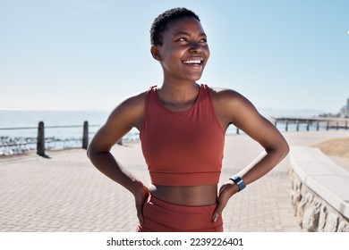 black woman, happy and thinking on beach sidewalk for fitness motivation, mental health and runner rest outdoor. African woman, athlete smiling and confident mindset vision by Cape Town seaside - Powered by Shutterstock