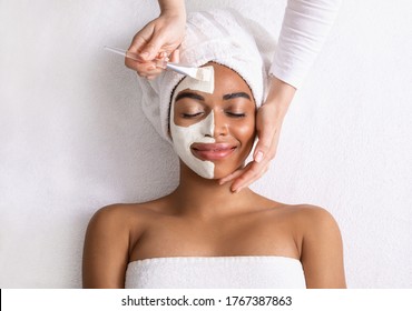 Black Woman Having White Clay Mask On Half Of Her Face, Top View