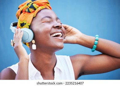 Black woman, headphones and happy or smile for podcast, audio motivation or streaming music online in blue studio background. African woman, happiness and lifestyle culture or relax with headset - Shutterstock ID 2235216407