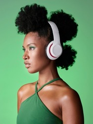 Black Woman With Headphones Listening To Music Or Podcast On Green Studio Background Mockup Advertising And Marketing. African Gen Z Girl With Audio For Youth Lifestyle Or Streaming Service Mock Up