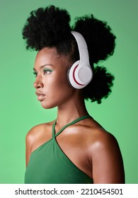 Black woman with headphones listening to music or podcast on green studio background mockup advertising and marketing. African gen z girl with audio for youth lifestyle or streaming service mock up