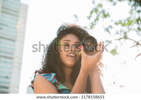 Foto Bild Eine lächelnde Frau, die eine Taube aus ihrer Hand füttert.