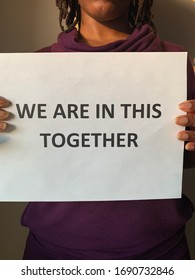 A Black Woman Holding A Sign Stating We Are In This Together. A Message Of Perseverance And Resilience In The Face Of CoVid Pandemic