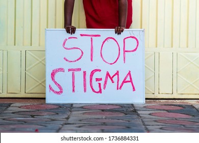 A Black Woman Holding A Sign For Stop Stigma Covid-19 Social Stigma. Concept On Education On Avoiding Social Stigma With People Infected With Corona Virus - Africa Millennial On Mass Education