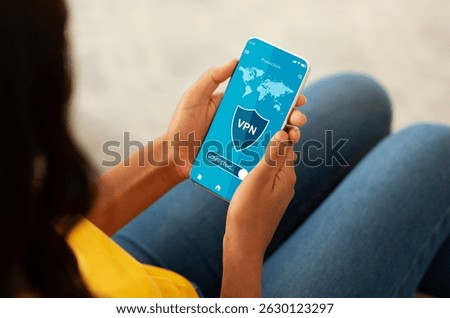 Black woman holding and using cellphone with vpn app