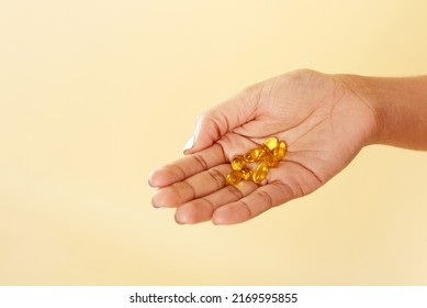 Black woman holding vitamin c pills. Smiling african lady using vitamins for healthy immunity or beauty. close hand - Shutterstock ID 2169595855
