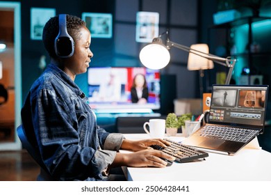 Black woman immersed in world of technology, wearing wireless headphones as she edits photos and videos. African american female filmmaker working with footage and sound, editing new project. - Powered by Shutterstock