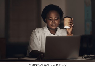 Black woman, laptop or night with coffee for deadline, project or design at office desk. Young African, female person or designer working late on computer with caffeine drink or beverage at workplace - Powered by Shutterstock