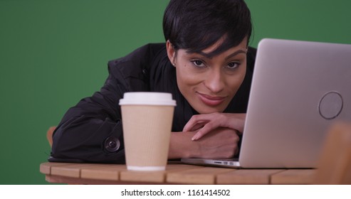 Black Woman With Laptop Resting Head On Cafe Table On Green Screen