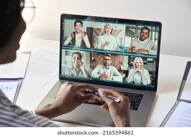 Black Woman Manager Leader Having Team Chat Virtual Meeting Group Video Conference Call With Diverse Business People Remote Working Online At Home Office. Teleconference Concept. Over Shoulder View